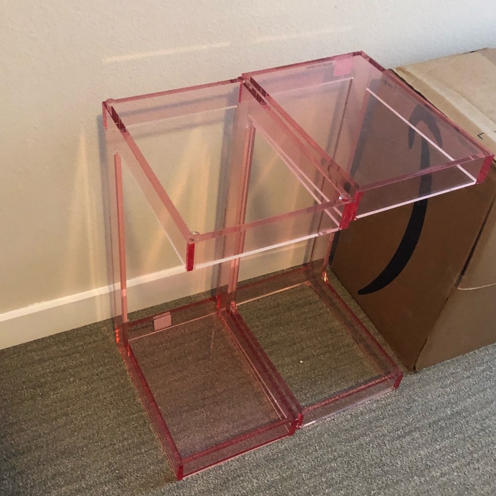 Two acrylic pink night tables